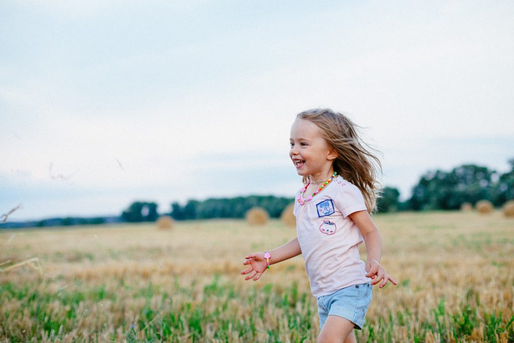 畑で走っている少女の写真